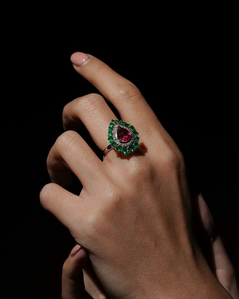 Ruby ring with emerald halo